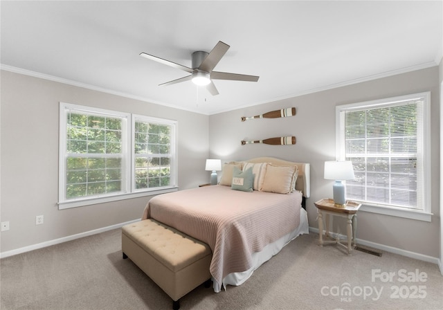 bedroom featuring light carpet, multiple windows, ceiling fan, and ornamental molding