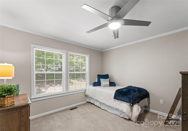 carpeted bedroom featuring ceiling fan and crown molding