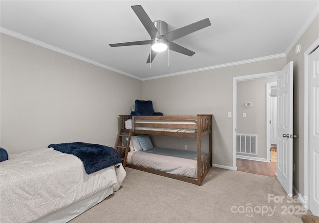 bedroom with light carpet, ceiling fan, and ornamental molding