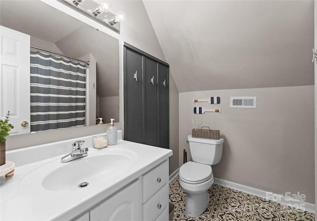 bathroom featuring tile patterned flooring, vanity, vaulted ceiling, and toilet