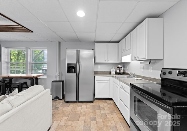 kitchen featuring white cabinets, a paneled ceiling, sink, and appliances with stainless steel finishes