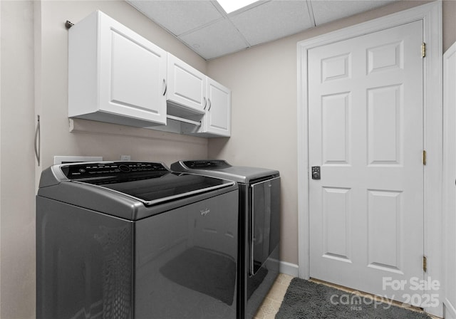 laundry area featuring cabinets, independent washer and dryer, and light tile patterned floors