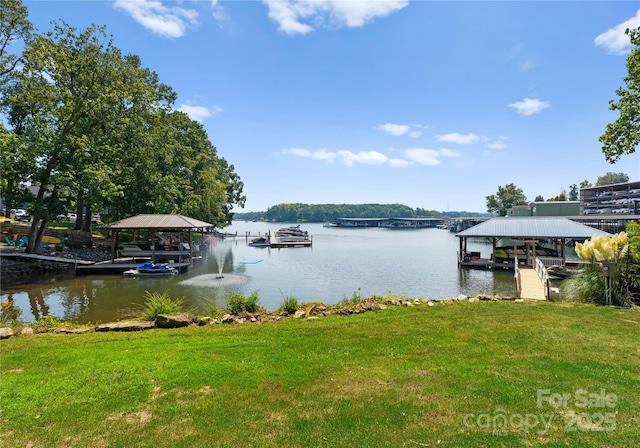 dock area with a water view and a lawn