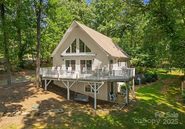 back of house featuring a yard and a wooden deck