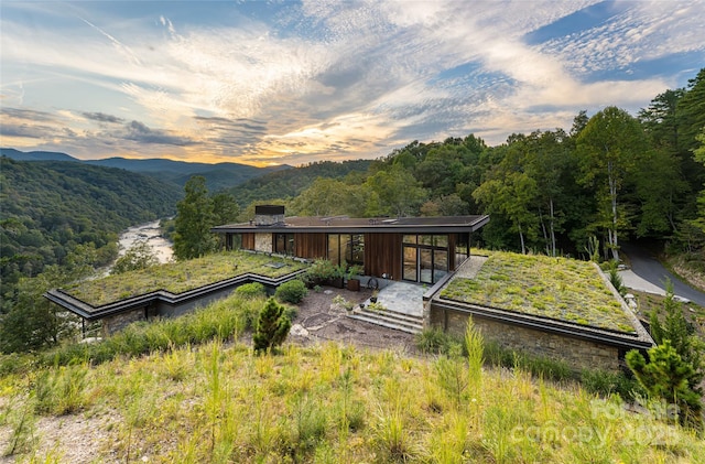 back house at dusk with a mountain view