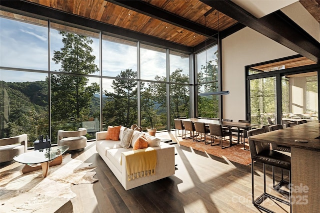 sunroom featuring beamed ceiling and wooden ceiling