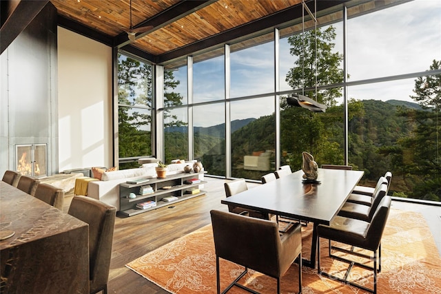 sunroom / solarium with a mountain view and wood ceiling