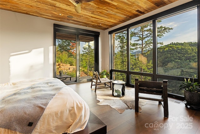 bedroom with access to exterior, hardwood / wood-style flooring, and wooden ceiling