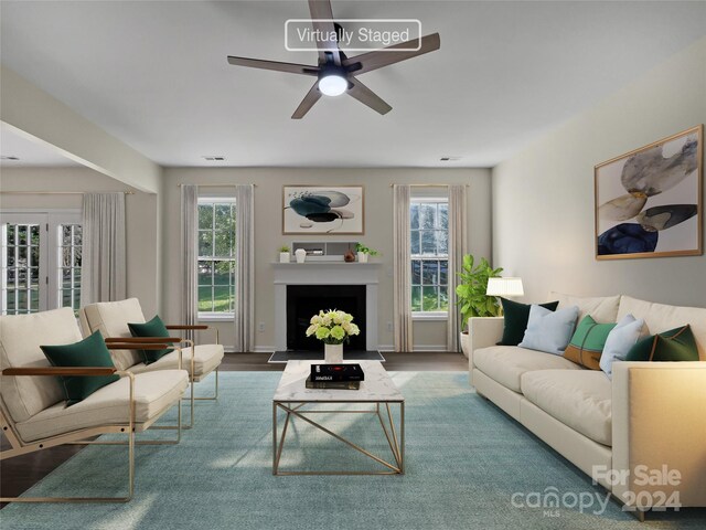 living room featuring ceiling fan, a healthy amount of sunlight, and hardwood / wood-style flooring