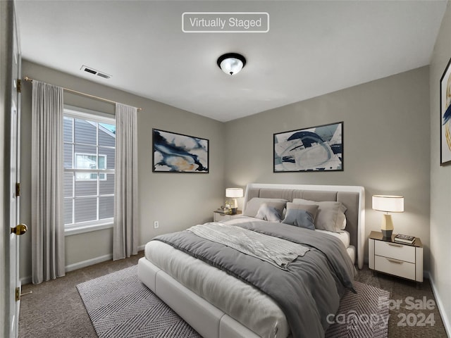 carpeted bedroom with baseboards and visible vents