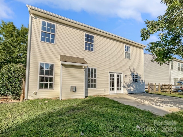 back of house with a yard, french doors, and a patio