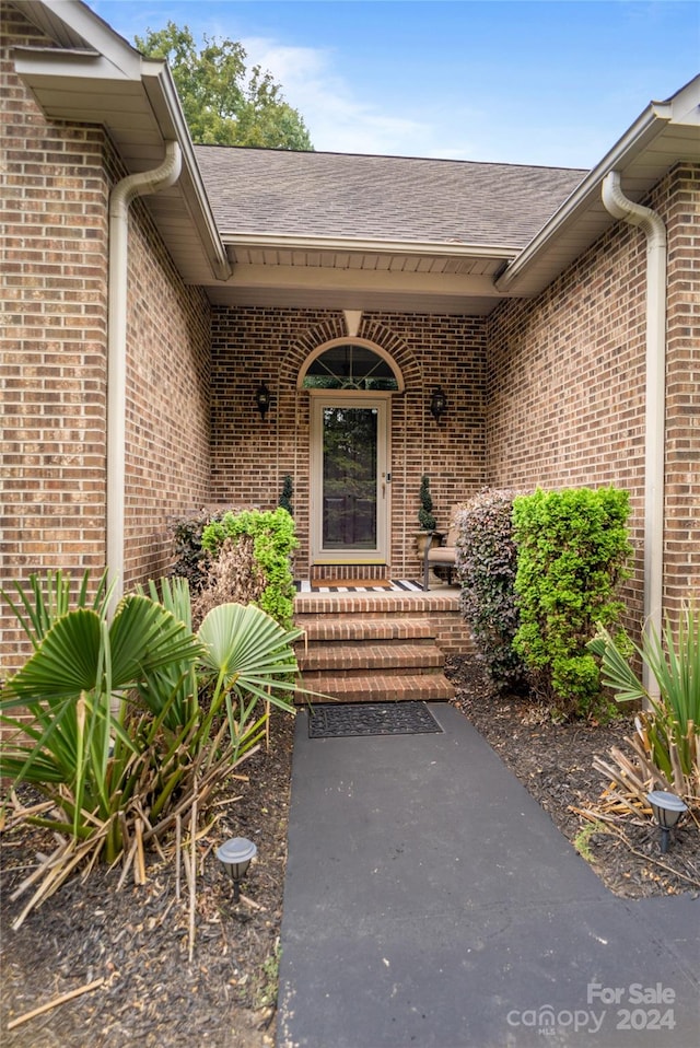 view of exterior entry featuring a porch