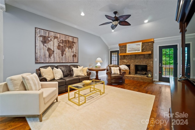 living room featuring ceiling fan, dark hardwood / wood-style floors, vaulted ceiling, and a wealth of natural light