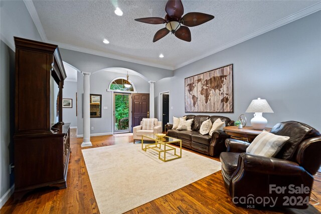 10235 Mount Holly Rd, Charlotte, NC 28214 - living room with decorative columns, dark hardwood / wood-style floors, and a textured ceiling