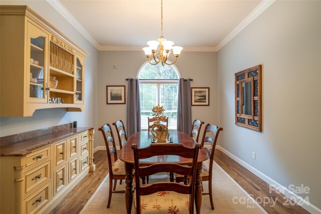 10235 Mount Holly Rd, Charlotte, NC 28214 - dining area with light hardwood / wood-style floors, ornamental molding, and a notable chandelier