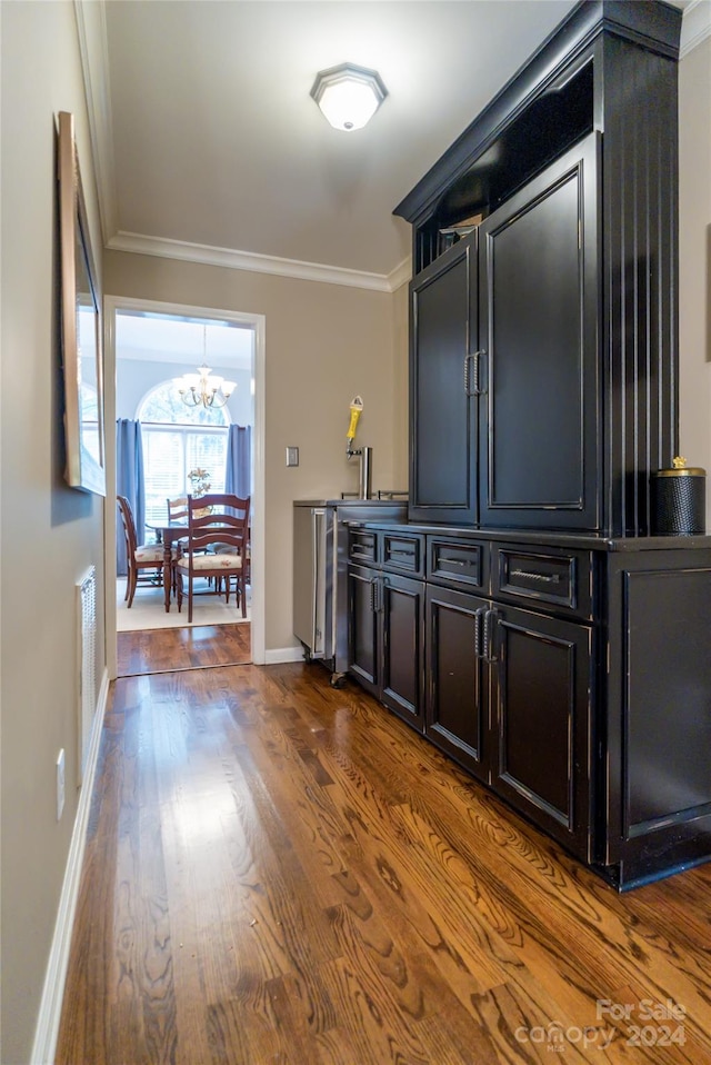 10235 Mount Holly Rd, Charlotte, NC 28214 - bar with a notable chandelier, dark wood-type flooring, and crown molding