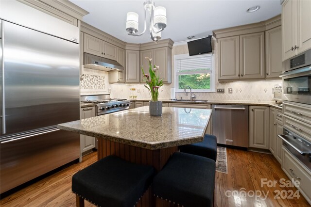 10235 Mount Holly Rd, Charlotte, NC 28214 - kitchen with wood-type flooring, a center island, sink, and stainless steel appliances