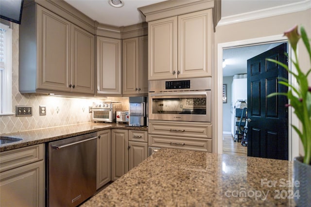 10235 Mount Holly Rd, Charlotte, NC 28214 - kitchen featuring light stone countertops, decorative backsplash, appliances with stainless steel finishes, and ornamental molding