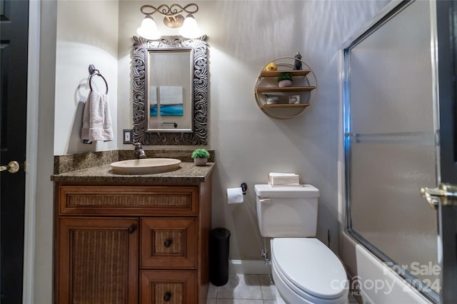 10235 Mount Holly Rd, Charlotte, NC 28214 - full bathroom featuring tile patterned floors, shower / bath combination with glass door, vanity, and toilet