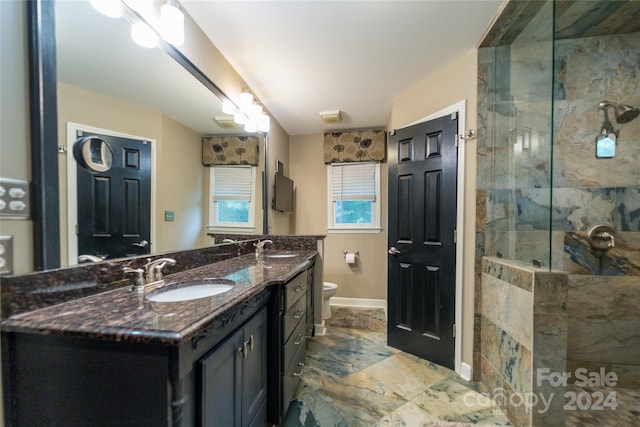 10235 Mount Holly Rd, Charlotte, NC 28214 - bathroom featuring a tile shower, vanity, and toilet