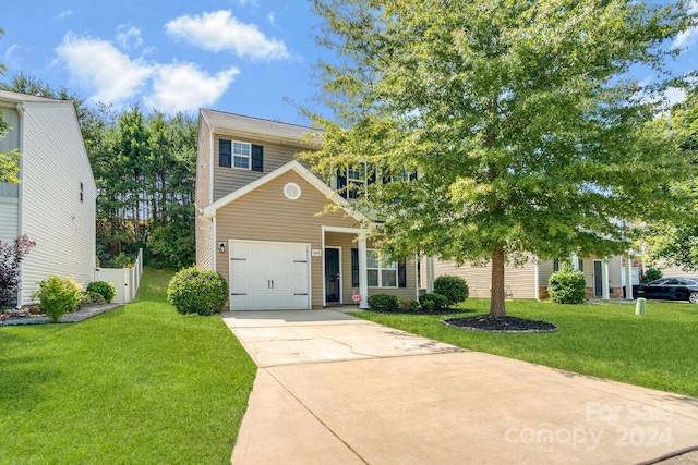 view of front of house featuring a front yard and a garage