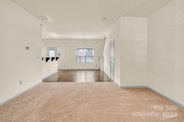 unfurnished living room with hardwood / wood-style flooring