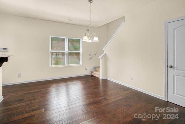 unfurnished dining area featuring dark hardwood / wood-style floors and a chandelier