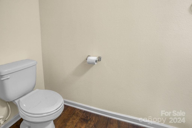 bathroom with toilet and hardwood / wood-style flooring