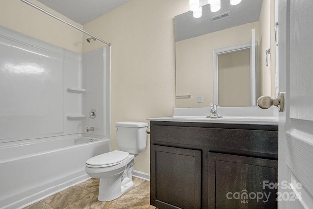 full bathroom with tile patterned flooring, vanity, toilet, and  shower combination