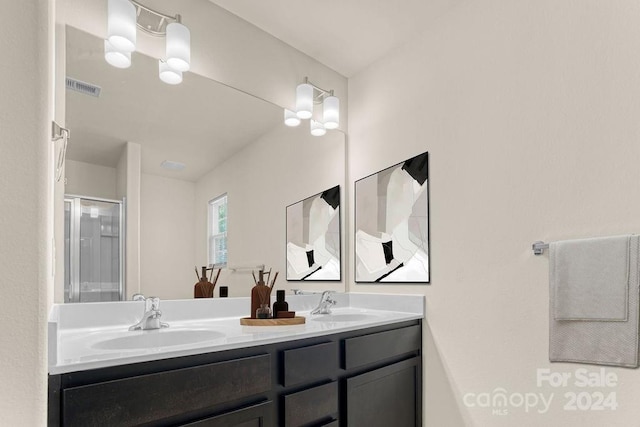 bathroom featuring vanity, a chandelier, and walk in shower