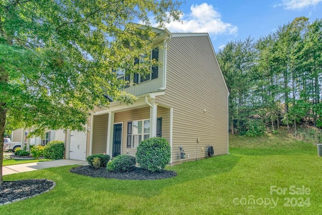 view of front of property with a garage and a front lawn