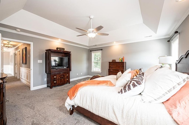 bedroom with a tray ceiling, carpet flooring, a ceiling fan, and crown molding