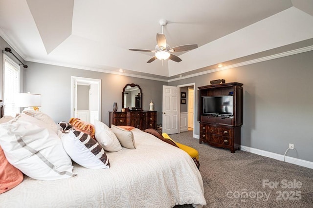 bedroom with ceiling fan, carpet floors, baseboards, a tray ceiling, and crown molding