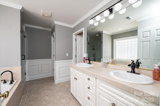 full bath featuring a shower stall, crown molding, visible vents, and a sink