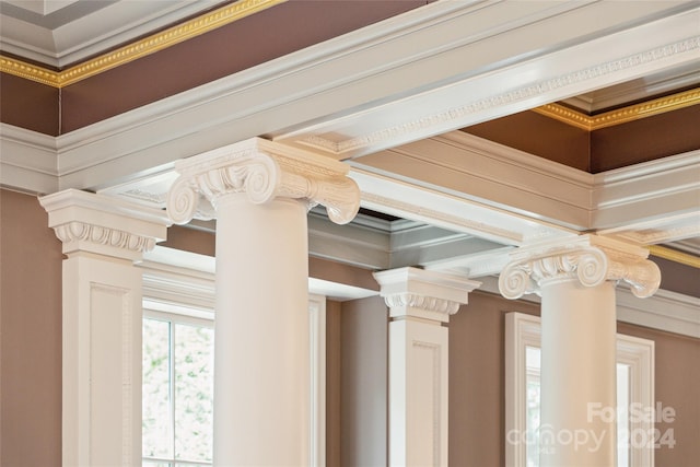 interior details featuring crown molding and ornate columns