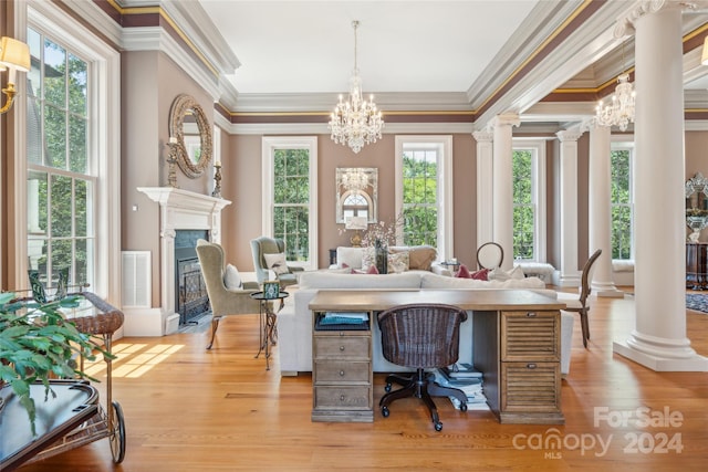 dining space with hardwood / wood-style floors, a notable chandelier, and a healthy amount of sunlight