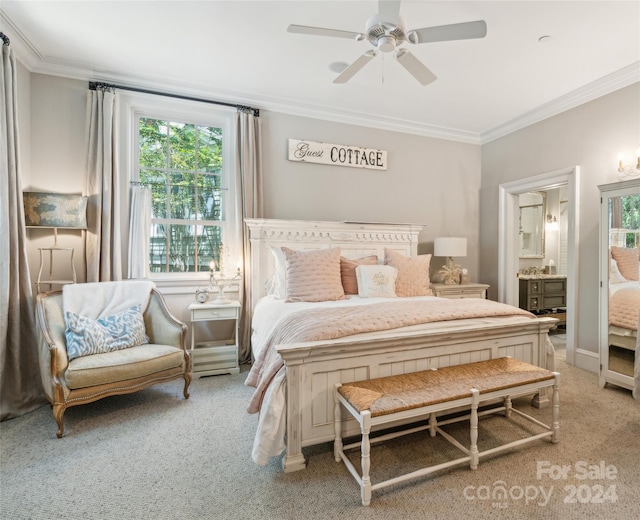 bedroom with light carpet, multiple windows, ensuite bathroom, and ceiling fan