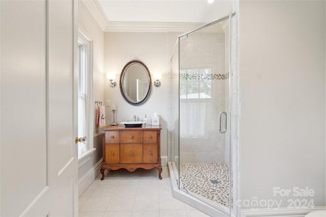 bathroom with vanity, ornamental molding, an enclosed shower, and tile patterned floors