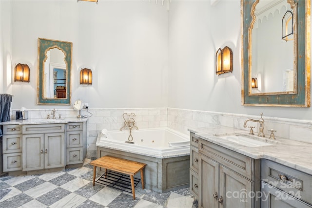 bathroom featuring vanity, tiled bath, and tile walls