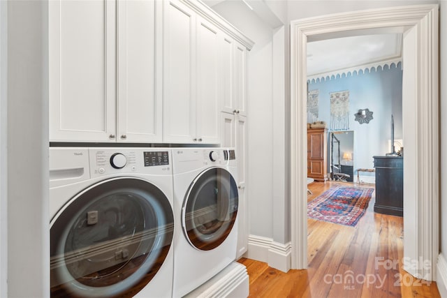 washroom with independent washer and dryer and light wood-type flooring