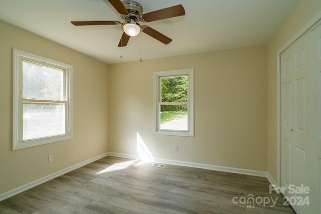 interior space with ceiling fan, light hardwood / wood-style flooring, and a closet