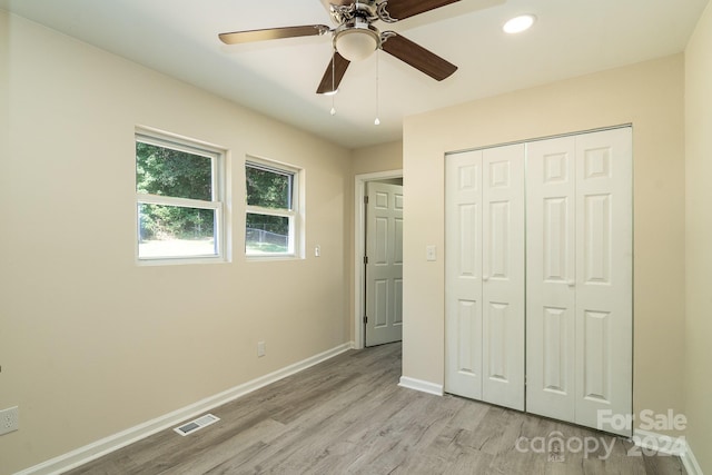 unfurnished bedroom with a closet, ceiling fan, and light wood-type flooring