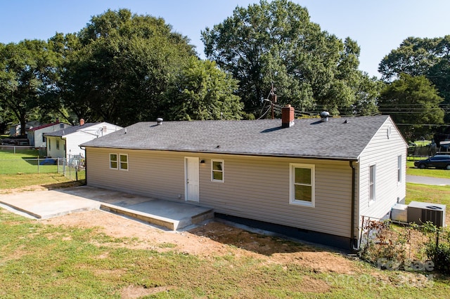 back of house featuring a patio, central air condition unit, and a lawn