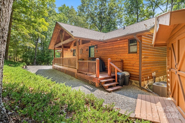 wooden deck featuring cooling unit