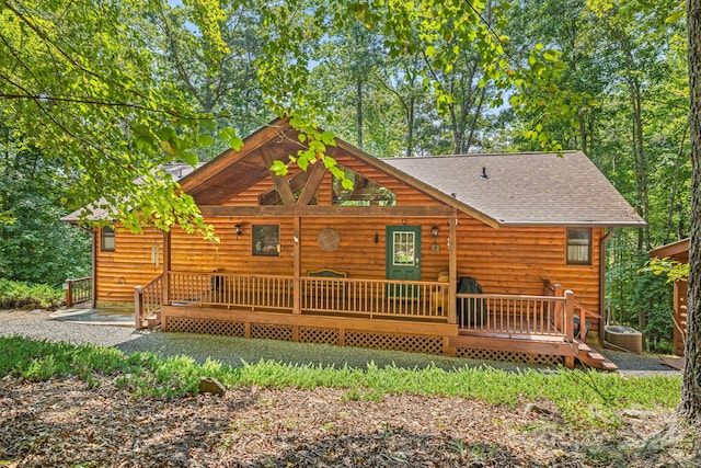 rear view of house with a shingled roof