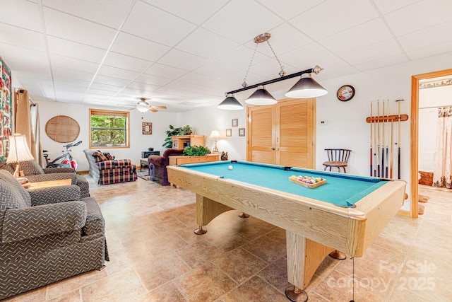 recreation room with a drop ceiling, a ceiling fan, and billiards
