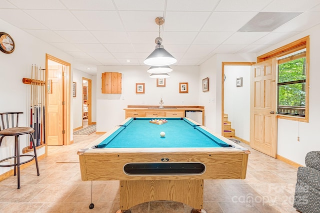 playroom with baseboards, pool table, a drop ceiling, and light stone finish flooring