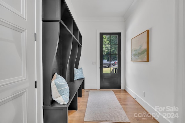 mudroom featuring light wood-type flooring and ornamental molding