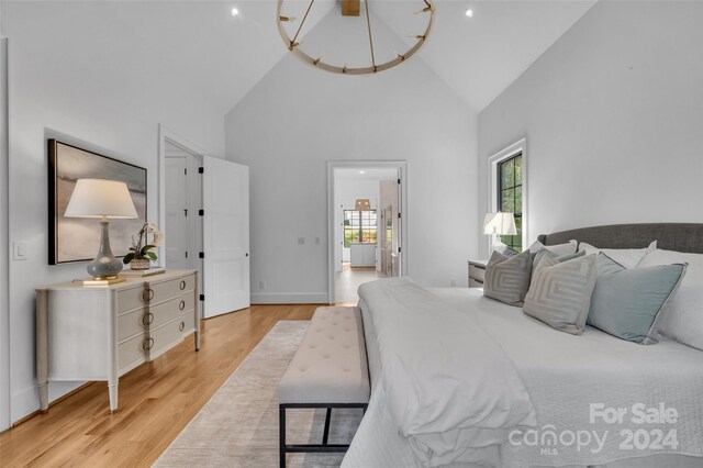 bedroom featuring light hardwood / wood-style flooring and high vaulted ceiling