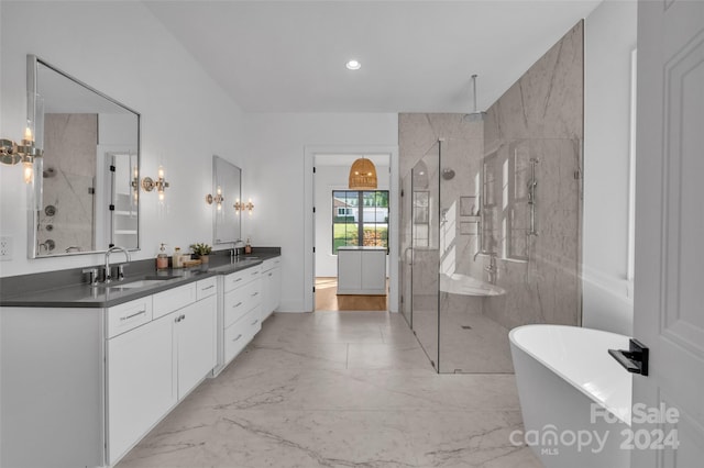 bathroom featuring vanity and separate shower and tub